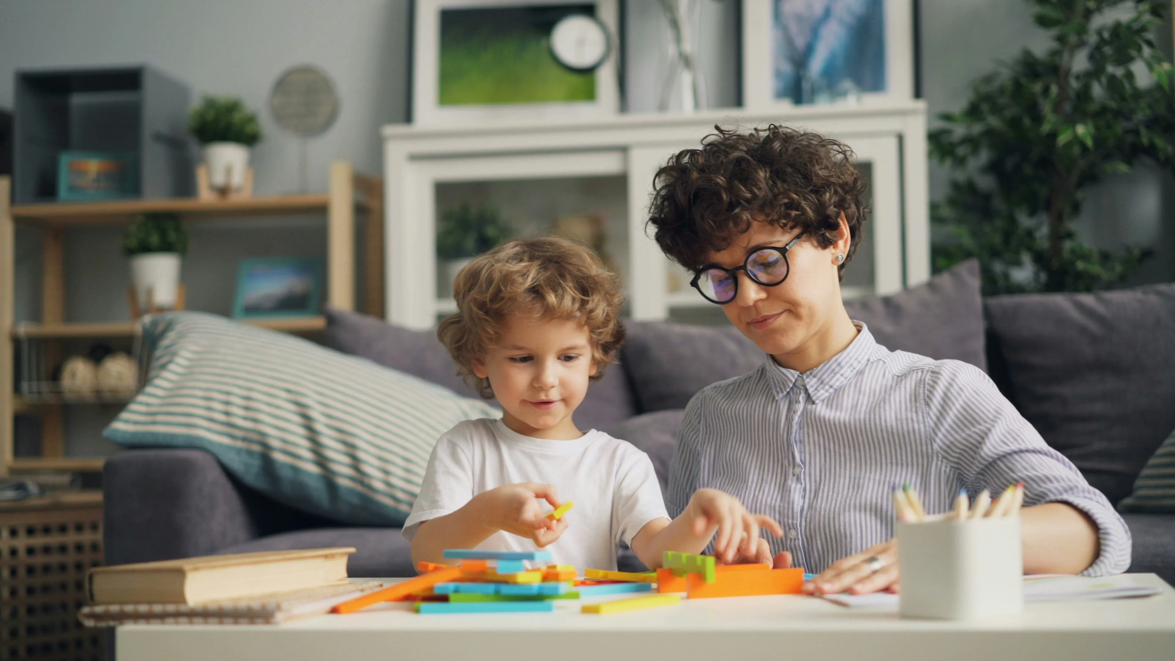 mother and child playing with toys on a table
